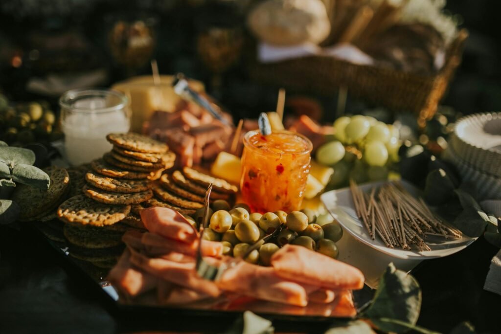 A beautifully arranged charcuterie board featuring meats, cheeses, fruits, and crackers in artistic presentation.