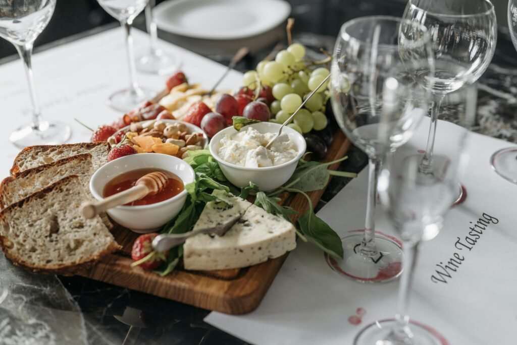 A delicious spread of cheeses, fruits, and bread on a charcuterie board, ready for wine tasting.