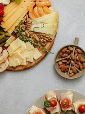 A gourmet selection of cheeses, fruits, and nuts on a charcuterie platter.